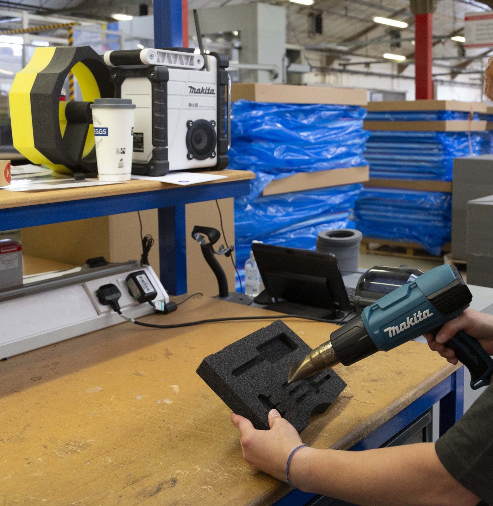 finishing touches and quality check on foam insert. Heat gun smooths all the imperfections on foam material